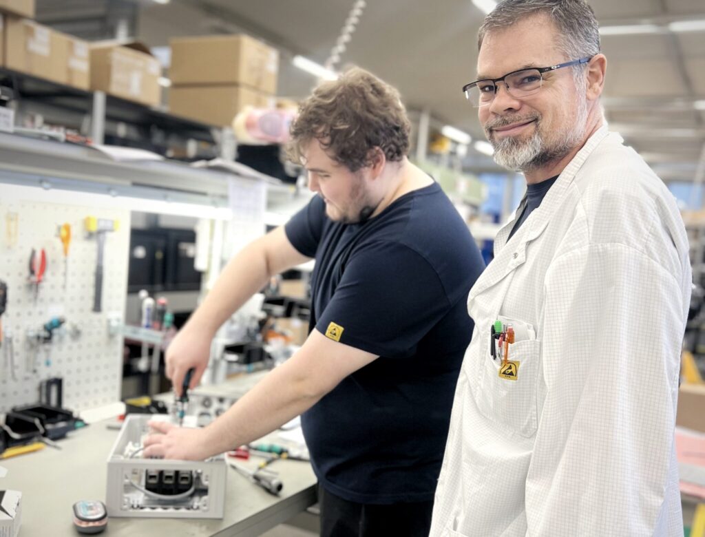 Two technicians working in electromechanical contract manufacturing and assembly at Inission's Lohja factory.