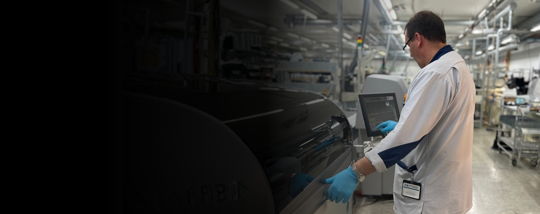 Inission Lohja electronics factory – an employee operating modern equipment in an electronics contract manufacturing environment.